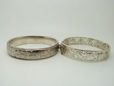 A hallmarked silver bangle with engraved foliate decoration and a silver filigree example