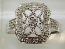 A 9ct white gold ring set with diamonds in a rectangular cluster, 2.