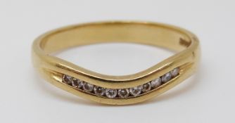 An 18ct gold ring set with diamonds in a wave setting, 2.