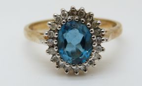A 9ct gold ring set with a blue topaz surrounded by diamonds (size Q)