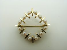 A yellow metal brooch set with pearls in a square, 2.