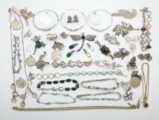 A collection of silver jewellery including a bracelet set with garnets, brooch set with garnets,