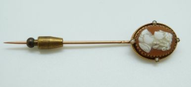 A Victorian stick pin set with an oval cameo and seed pearls to the rope twist border, length 7.
