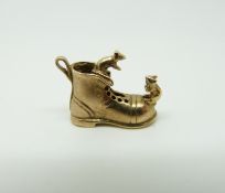 A 9ct gold charm in the form of a boot with two mice,
