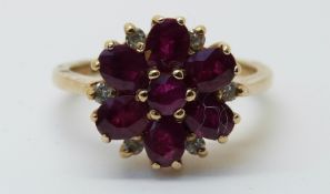 A white gold ring set with rubies and diamonds in a flower cluster (size K)