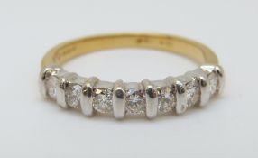 An 18ct gold ring set with seven diamonds in a white gold setting, 3.