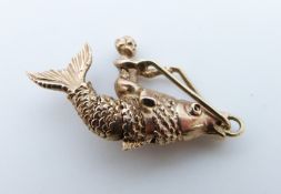 A 9ct pendant/ charm in the form of a cherub riding a fish, 3.