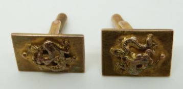 A pair of Chinese 9ct gold cufflinks with dragons to the front (9.