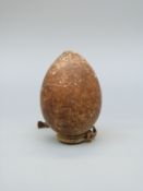 A stoneware or pottery ovoid vessel probably of some antiquity, with collared rim and hanging loop,