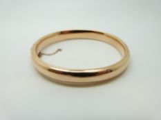 A rose gold bangle, 14.