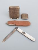 A hallmarked silver and mother of pearl fruit knife and two hallmarked silver vestas with engraved