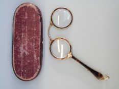 A pair of cased yellow metal and tortoiseshell lorgnettes in case