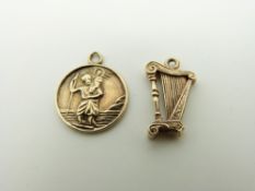 A 9ct gold charm in the form of a harp and a 9ct gold St Christopher, 3.
