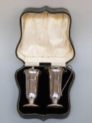 A George V hallmarked silver strawberry set comprising sugar sifter and cream jug, Sheffield 1926,