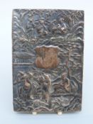 A Chinese white metal cigarette case embossed with figures, bamboo, trees and a bird,