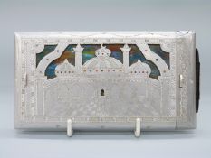 A novelty aluminium cigarette dispenser with spring loaded mechanism and temple decoration,