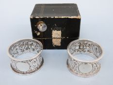 A cased pair of Victorian hallmarked silver napkin rings, Birmingham 1892 maker Nathan & Hayes,