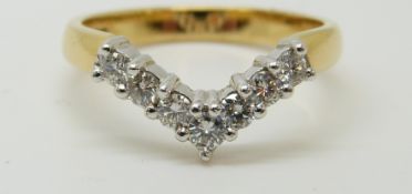 An 18ct gold ring set with diamonds in a V shape setting, 3.