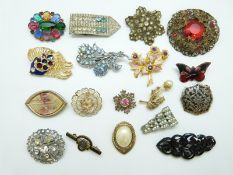 A collection of brooches including filigree, enamel butterfly,