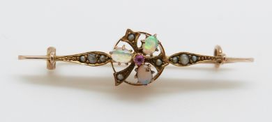 A yellow metal brooch marked 333 set with three opals, a ruby and seed pearls,