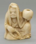 A Japanese Meiji period carved ivory netsuke of a man holding a bowl/gourd, 3.