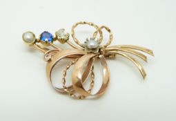 A 14ct gold brooch in a stylized bouquet design set with an old cut diamond of approximately 0.