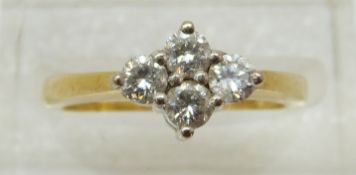 An 18ct gold ring set with four diamonds, total diamond weight approximately 0.