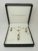 A 9ct gold pendant set with diamonds and peridot with matching earnings