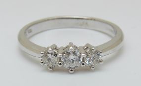 An 18ct white gold ring set with three diamonds, total diamond weight 0.