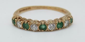 A 9ct gold ring set with emeralds and cubic zirconia (size K)