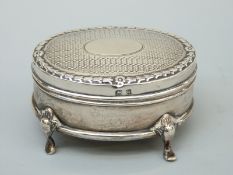 A George V hallmarked silver four footed casket raised on four shaped feet, B'ham 1911,