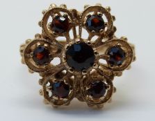 A 9ct gold ring set with garnets in a cluster (size M)