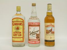 Three bottles of spirits comprising Famous Grouse whisky 70cl 40% vol, Gordon's gin 1 litre 47.