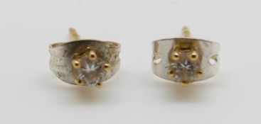 A pair of 18ct gold earrings each set with a diamond