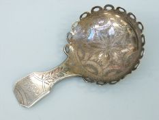A Georgian hallmarked silver caddy spoon with unusual looped rim,