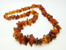 An amber necklace of translucent irregular shaped beads 50g, 53cm long.