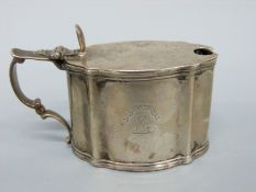An Edward VII hallmarked silver mustard with blue glass liner, London 1908 marked C.S.