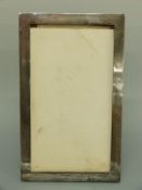 A large George VI hallmarked silver photograph frame to suit 12x7