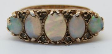 A 9ct gold ring set with five graduated opals (size O)