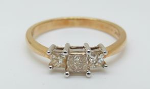 An 18ct gold ring set with three princess cut diamonds, total diamond weight approximately 0.