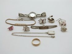 Two silver identity bracelets, a silver locket,