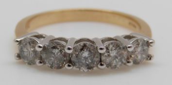 An 18ct gold ring set with five diamonds, the centre diamond approximately 0.