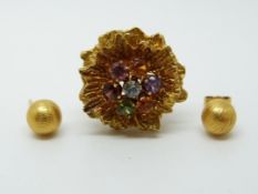 An 18ct gold earring in the form of a flower set with amethyst, citrine,