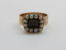 A 9ct gold ring set with plaited hair to the centre surrounded by seed pearls, 5.