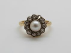 An 18ct gold Victorian ring set with a pearl to the centre surrounded by diamonds, 4.