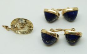 A pair of yellow metal cufflinks set with lapis lazuli cabochons