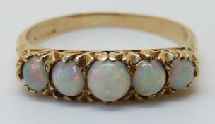 An 18ct gold ring set with five opals (size V)