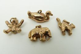 Four 9ct gold charms, elephant, duck, bear and cat, 11.