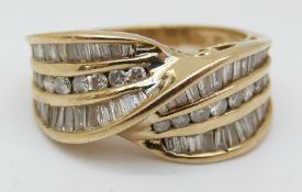 A 9ct gold ring set with round and baguette cut diamonds in a twist setting (size O)
