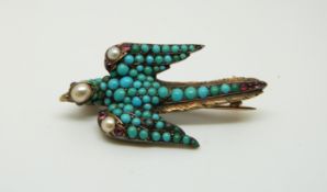 A Victorian gilt brooch in the form of a swallow set with turquoise cabochons,